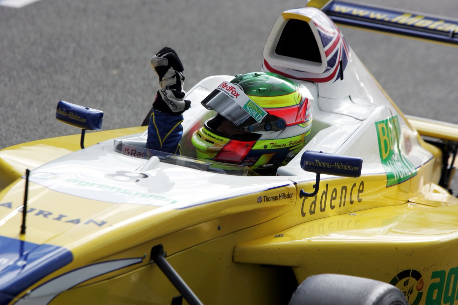 Thomas Hillsdon waving from the cockpit at Silverstone